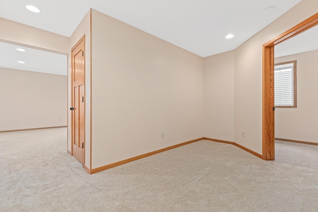 empty room with baseboards, recessed lighting, and carpet
