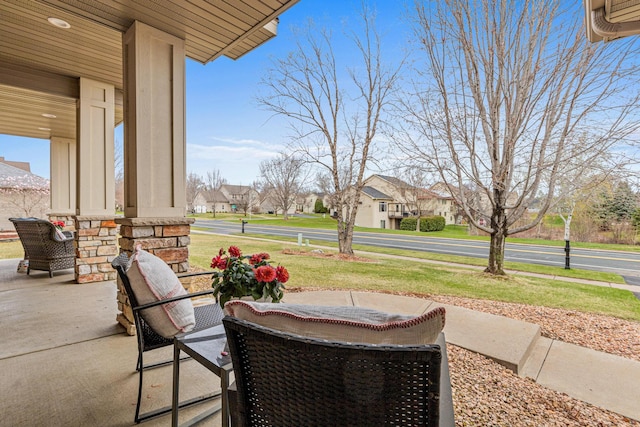 view of patio / terrace featuring a porch and a residential view