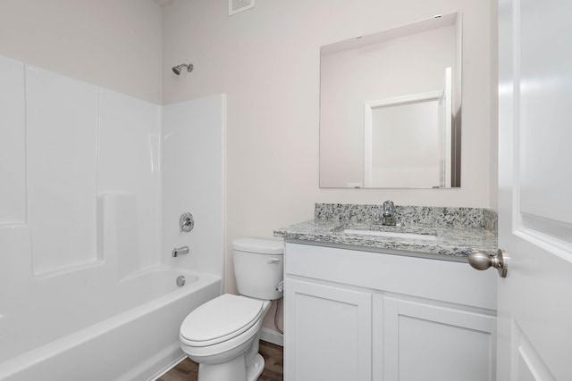 bathroom featuring wood finished floors, shower / bathing tub combination, vanity, and toilet