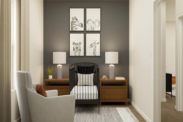 sitting room featuring carpet flooring and baseboards