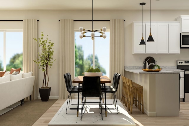 dining room featuring an inviting chandelier, baseboards, and light wood-type flooring