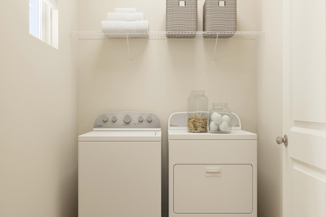 washroom with washing machine and clothes dryer and laundry area