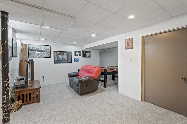 finished basement featuring a drop ceiling, recessed lighting, and carpet