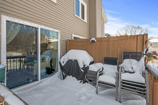 snow covered patio with fence