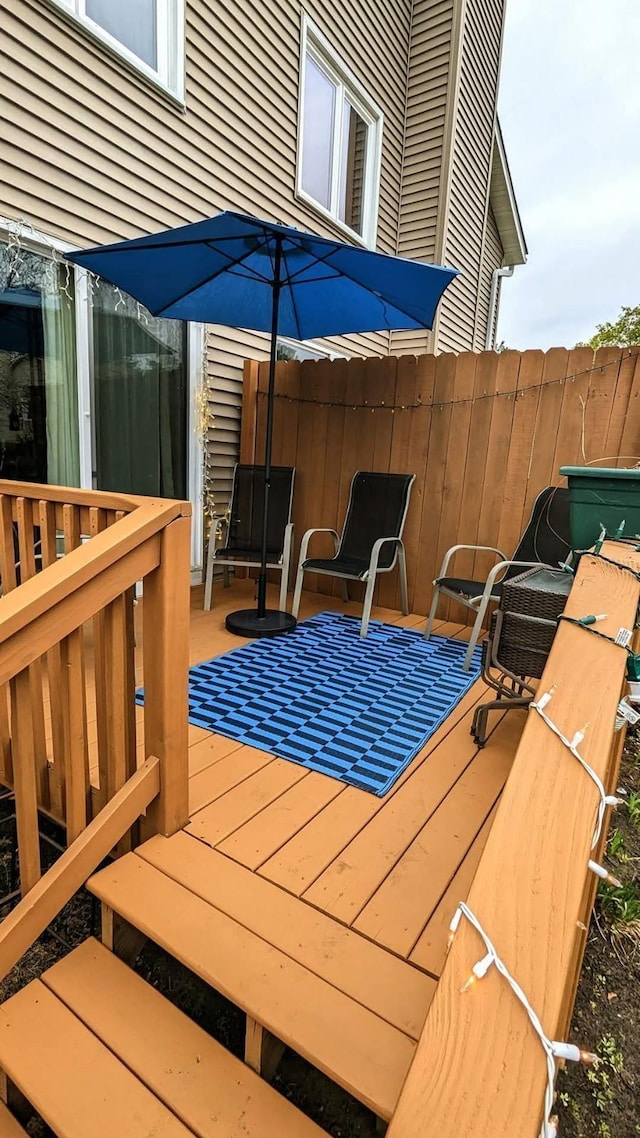 wooden terrace featuring fence