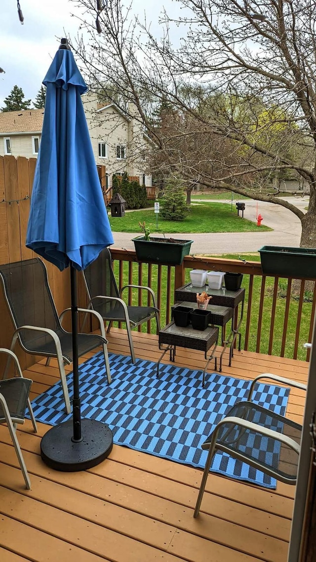 wooden terrace featuring a yard