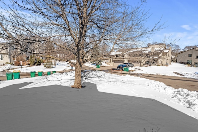 yard layered in snow with a residential view