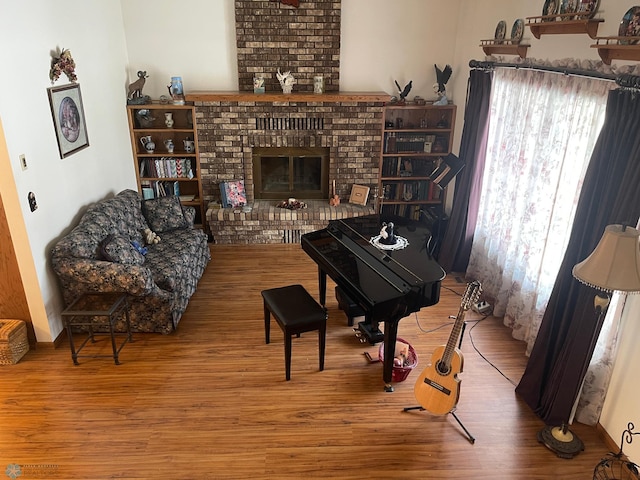 living area featuring a fireplace and wood finished floors