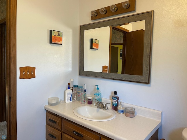 bathroom featuring toilet and vanity