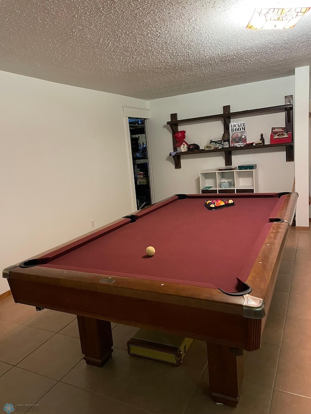 rec room featuring tile patterned floors, pool table, and a textured ceiling