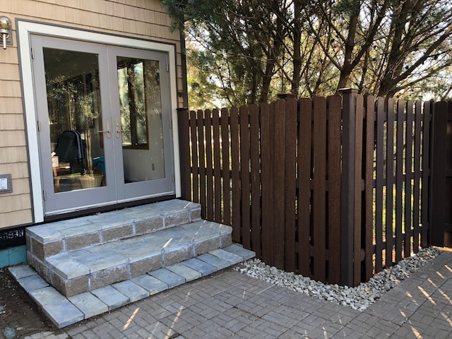 property entrance with french doors and fence