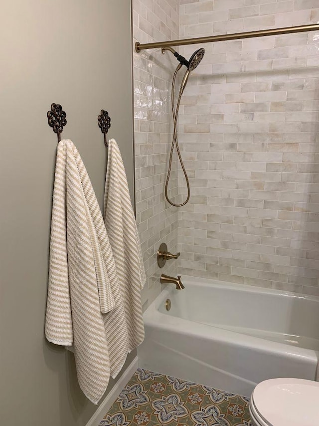 bathroom with  shower combination, tile patterned flooring, and toilet