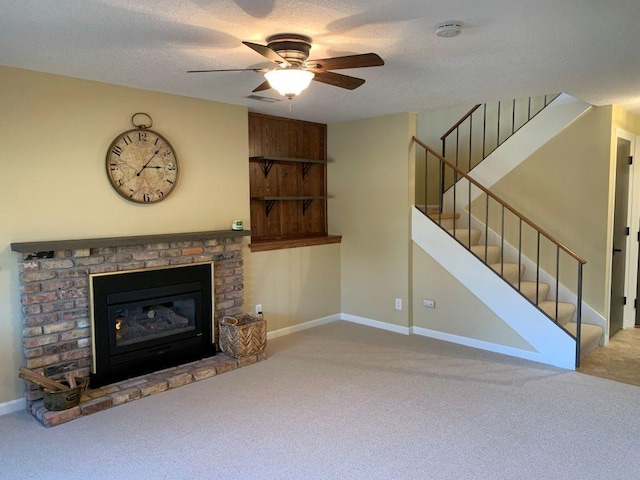 unfurnished living room featuring a brick fireplace, carpet, stairway, and a textured ceiling