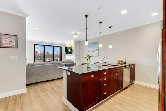 kitchen featuring a sink, stainless steel dishwasher, a peninsula, and ornamental molding