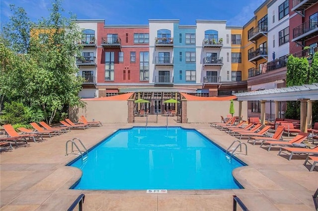 community pool featuring a pergola and a patio area