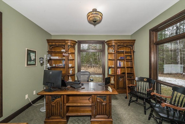 carpeted office featuring baseboards