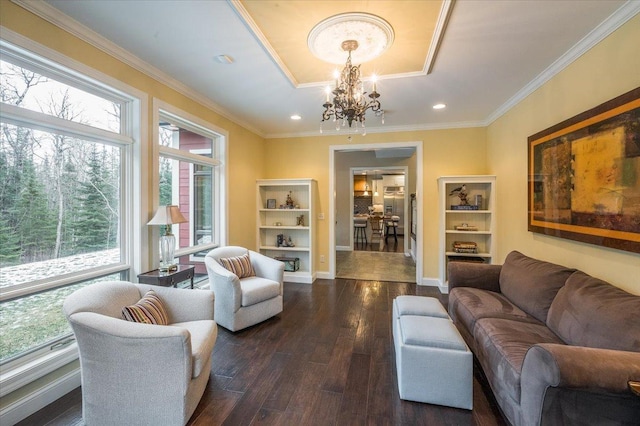 living area with a chandelier, dark wood-style flooring, and crown molding