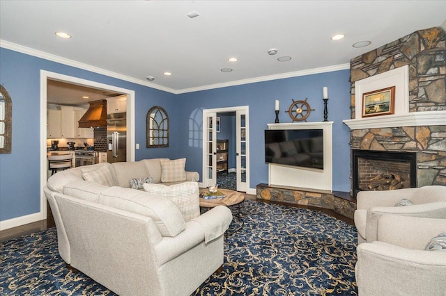 living area with ornamental molding, dark wood-style flooring, a fireplace, and baseboards