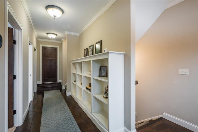 hallway with dark wood-style flooring, crown molding, and baseboards