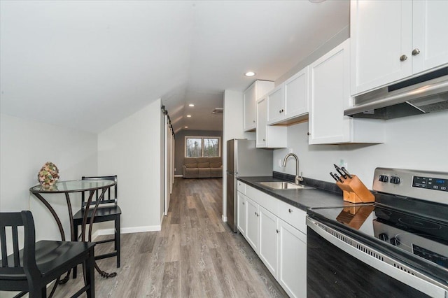 kitchen featuring a barn door, dark countertops, stainless steel electric range, under cabinet range hood, and white cabinetry