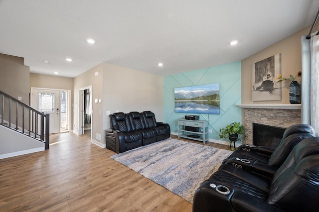 living area featuring recessed lighting, stairway, baseboards, and wood finished floors