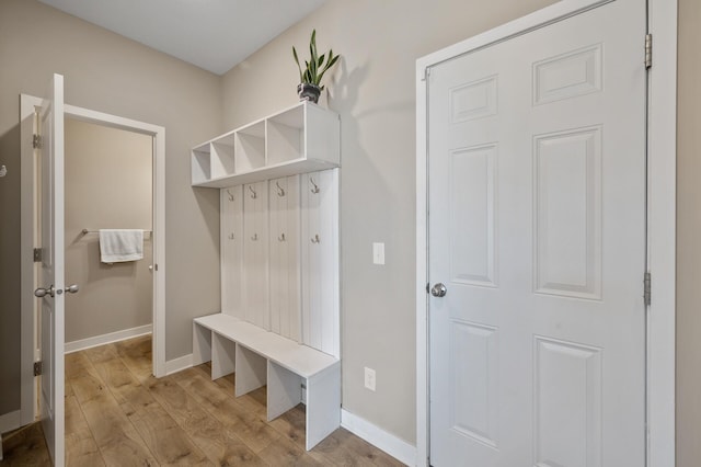 mudroom with light wood finished floors and baseboards