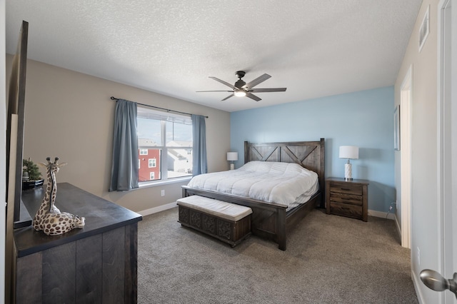 bedroom featuring baseboards, carpet floors, and a textured ceiling