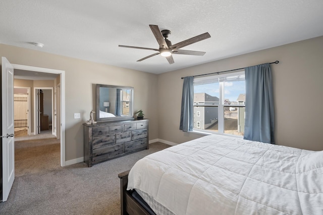 carpeted bedroom with baseboards, a textured ceiling, and a ceiling fan