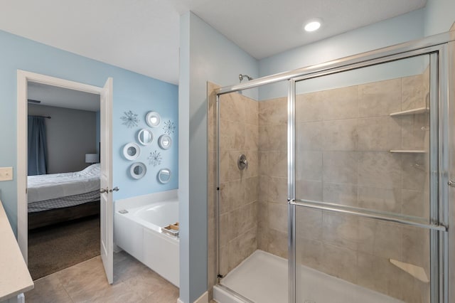 ensuite bathroom with a garden tub, tile patterned floors, a stall shower, and ensuite bathroom