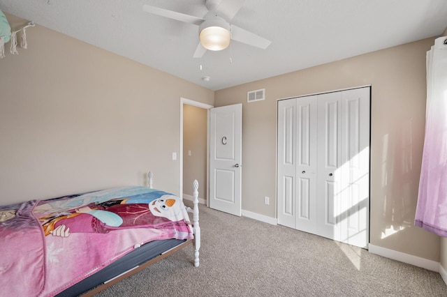 bedroom with visible vents, baseboards, carpet floors, a closet, and a ceiling fan