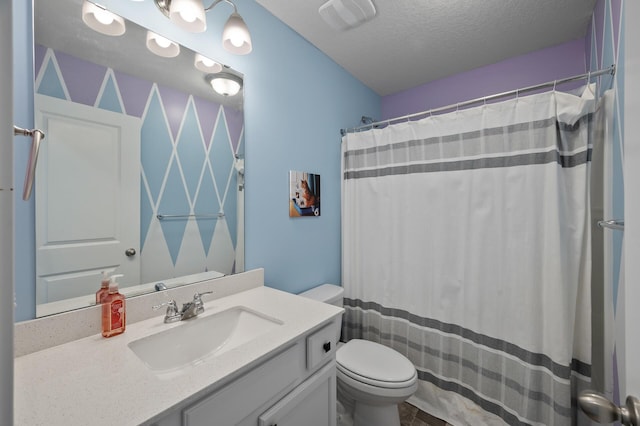 full bathroom with vanity, toilet, visible vents, and a textured ceiling