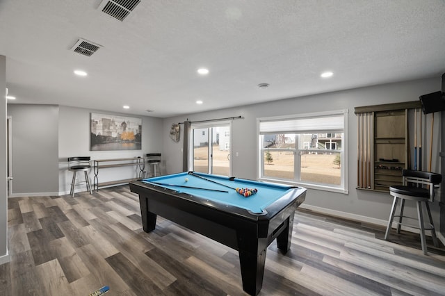 game room with visible vents, wood finished floors, and billiards