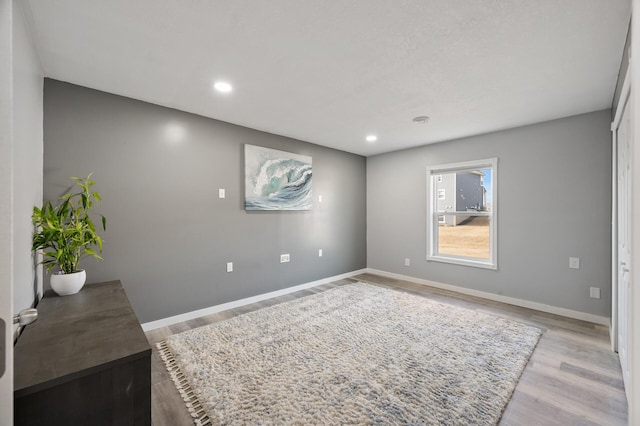 interior space featuring recessed lighting, baseboards, and light wood-style floors