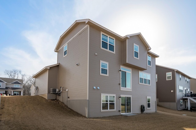 rear view of property with cooling unit and a residential view