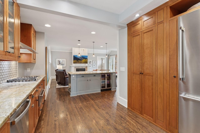 kitchen with beverage cooler, dark wood finished floors, stainless steel appliances, open floor plan, and backsplash