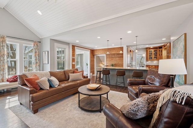 living area with recessed lighting, light wood-style floors, and vaulted ceiling