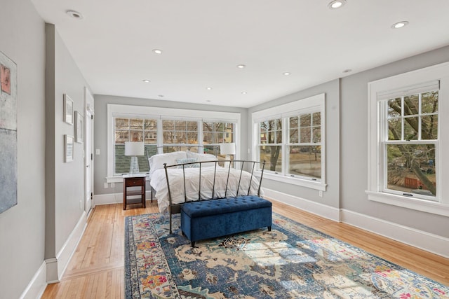 bedroom with recessed lighting, light wood-style flooring, and baseboards