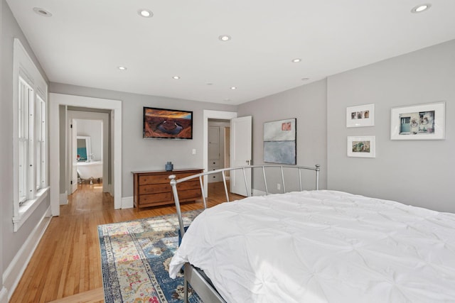 bedroom with recessed lighting, light wood-type flooring, and baseboards