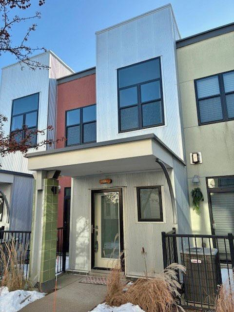 view of front of home featuring central air condition unit and fence