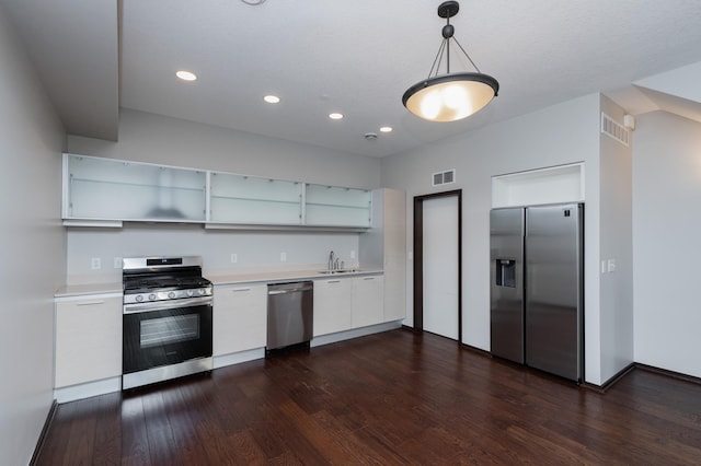 kitchen featuring stainless steel appliances, a sink, white cabinetry, light countertops, and open shelves