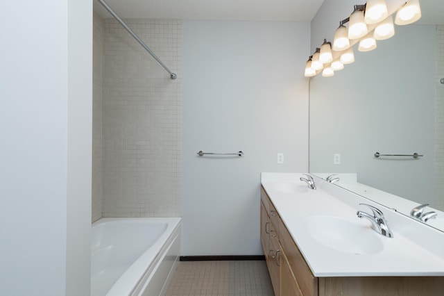 full bathroom with double vanity, baseboards, tub / shower combination, and a sink