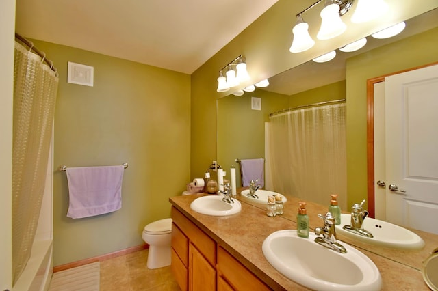 bathroom with double vanity, baseboards, and a sink