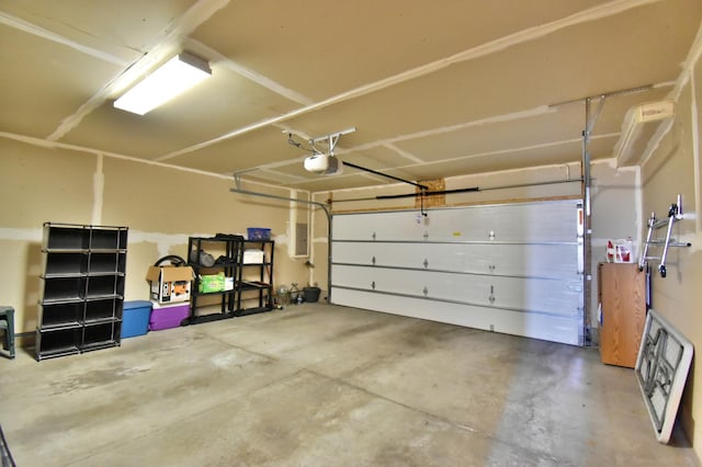 garage featuring electric panel and a garage door opener