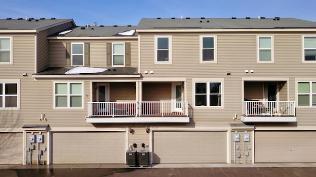 back of property with central air condition unit and an attached garage