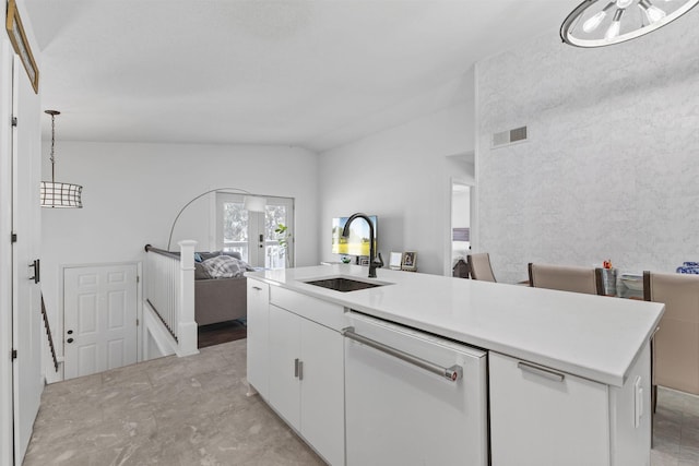 kitchen featuring visible vents, white dishwasher, a sink, light countertops, and white cabinets