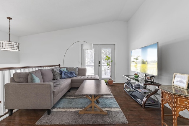 living room with dark wood-style flooring, french doors, and vaulted ceiling