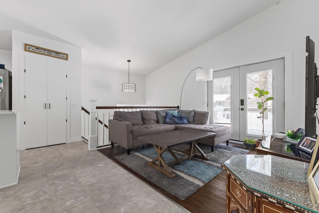 living room featuring french doors and vaulted ceiling