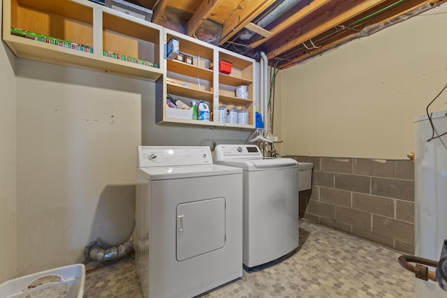 laundry room featuring washer and dryer, laundry area, and concrete block wall