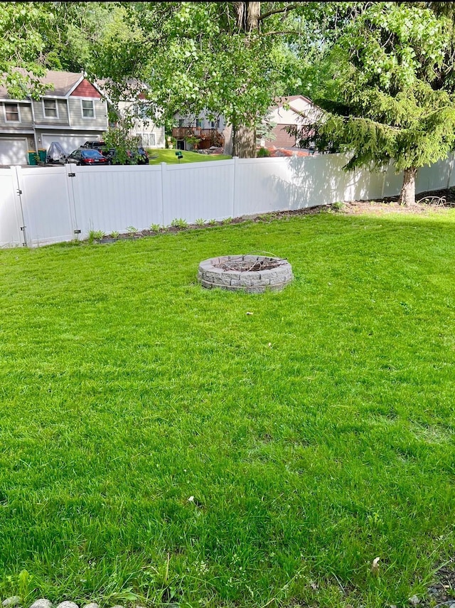 view of yard with a fire pit and a fenced backyard