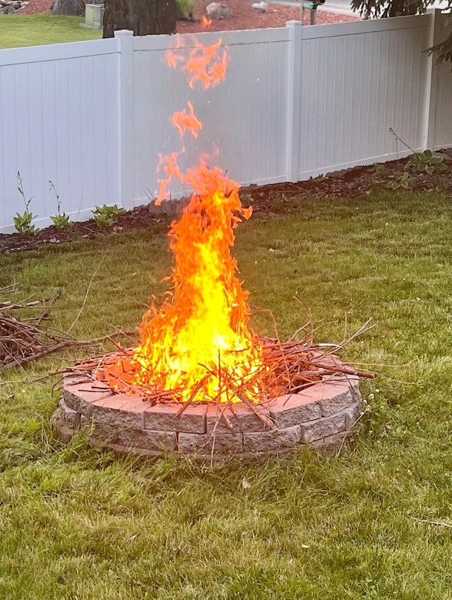 exterior details with a fire pit and fence